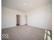 Large bedroom with neutral carpet, multiple doorways, and natural light at 6033 Granby Dr, Whitestown, IN 46075
