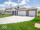 Charming one-story home with a spacious driveway and a three-car garage perfect for a growing Gathering at 6033 Granby Dr, Whitestown, IN 46075