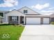Beautiful one-story brick home with a well-manicured lawn and a spacious three-car garage at 6033 Granby Dr, Whitestown, IN 46075