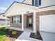 Close-up of the welcoming front porch with brick facade and a pathway leading to the front door at 6033 Granby Dr, Whitestown, IN 46075