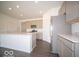 Modern kitchen with stainless steel appliances, gray cabinetry, and an island with a white countertop at 6033 Granby Dr, Whitestown, IN 46075