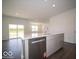Kitchen featuring an island with seating, sink, stainless steel dishwasher, and gray cabinetry at 6033 Granby Dr, Whitestown, IN 46075