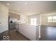 Well-lit kitchen featuring gray cabinets, stainless steel refrigerator, and center island at 6033 Granby Dr, Whitestown, IN 46075