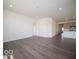An open-concept living area with wood-style flooring and neutral walls for versatile decor at 6033 Granby Dr, Whitestown, IN 46075