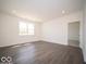 Spacious living room with lots of natural light and wood-style flooring throughout at 6033 Granby Dr, Whitestown, IN 46075