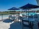 Relaxing pool area with tables, chairs and sun umbrellas for residents to enjoy on a sunny day at 6033 Granby Dr, Whitestown, IN 46075