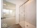 Bathroom features modern walk-in shower and an adjacent bedroom at 6047 Granby Dr, Whitestown, IN 46075