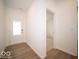 Bright entryway with wood-look flooring and a view into the adjacent room at 6047 Granby Dr, Whitestown, IN 46075