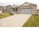 Beautiful single-story home with a two-car garage and a long concrete driveway at 6047 Granby Dr, Whitestown, IN 46075