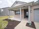 Inviting covered front porch with brick columns and a view of the landscaped yard at 6047 Granby Dr, Whitestown, IN 46075