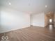Large living room with modern recessed lighting and wood-look flooring at 6047 Granby Dr, Whitestown, IN 46075