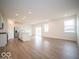 Open-concept living space with stainless steel appliances and wood-look floors at 6047 Granby Dr, Whitestown, IN 46075