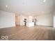 This open-concept living space features recessed lighting, and flows into the kitchen at 6047 Granby Dr, Whitestown, IN 46075