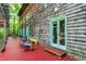 Inviting deck with vibrant red flooring, wood shingle siding, and natural light, perfect for outdoor relaxation at 6377 N Tutterow Rd, Monrovia, IN 46157
