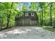 Three-car detached garage nestled amongst mature trees and gravel driveway at 6377 N Tutterow Rd, Monrovia, IN 46157
