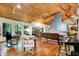 Well-lit living room featuring wooden floors, vaulted wood ceilings, and large windows offering serene views at 6377 N Tutterow Rd, Monrovia, IN 46157