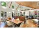 Stunning living room featuring vaulted wood ceilings, a long wooden dining table, and built-in bookshelves at 6377 N Tutterow Rd, Monrovia, IN 46157