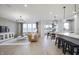 Bright living room with large windows, leather sofa, and a modern chandelier at 803 Allandale Ave, Westfield, IN 46074