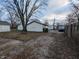 Backyard with detached garage and gravel driveway at 837 S Warman S Ave, Indianapolis, IN 46221