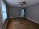Simple bedroom with hardwood floors and a ceiling fan at 837 S Warman S Ave, Indianapolis, IN 46221