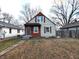 Two-story house with wood and vinyl siding, and a small yard at 837 S Warman S Ave, Indianapolis, IN 46221