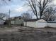 A detached single-car garage with a gravel driveway at 837 S Warman S Ave, Indianapolis, IN 46221