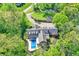 Aerial view of an estate home featuring an in-ground pool and mature trees at 8602 Frontgate Ln, Indianapolis, IN 46256