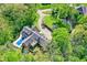 Estate home featuring an in-ground pool, mature trees, landscaping, and private drive at 8602 Frontgate Ln, Indianapolis, IN 46256
