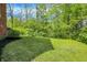 A spacious backyard with lush lawn and natural border in a tranquil, shaded setting at 8602 Frontgate Ln, Indianapolis, IN 46256