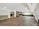 Expansive basement with brick flooring, fireplace, and access to the exterior at 8602 Frontgate Ln, Indianapolis, IN 46256