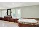 A large bathroom with a soaking tub, a vanity with a mirror, and three windows at 8602 Frontgate Ln, Indianapolis, IN 46256