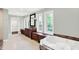 Primary bath featuring a soaking tub, dark wood cabinets, and large windows at 8602 Frontgate Ln, Indianapolis, IN 46256
