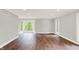 A light-filled bedroom with hardwood floors, large windows and neutral wall color at 8602 Frontgate Ln, Indianapolis, IN 46256