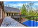 A custom tiled deck overlooks the backyard and features iron railings and an overhead lighting system at 8602 Frontgate Ln, Indianapolis, IN 46256
