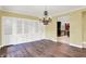 Elegant dining room features hardwood floors, a large built-in, and a view to the kitchen at 8602 Frontgate Ln, Indianapolis, IN 46256