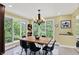Bright dining room featuring a modern table set with black chairs and backyard view at 8602 Frontgate Ln, Indianapolis, IN 46256