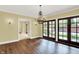 Dining room features hardwood floors, chandelier, french doors to patio, and hall access at 8602 Frontgate Ln, Indianapolis, IN 46256
