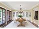 Elegant dining room with a rustic table, chandelier, and built-in cabinets at 8602 Frontgate Ln, Indianapolis, IN 46256