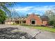 A stately brick home featuring a three-car garage and manicured landscaping at 8602 Frontgate Ln, Indianapolis, IN 46256