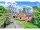 Stately brick home with manicured lawn, a long driveway and mature trees at 8602 Frontgate Ln, Indianapolis, IN 46256