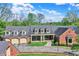 Beautiful home featuring a covered front porch, a three-car garage and lush landscaping at 8602 Frontgate Ln, Indianapolis, IN 46256