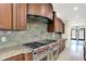 Chef's kitchen features stainless steel appliances, custom cabinets, and granite countertops at 8602 Frontgate Ln, Indianapolis, IN 46256
