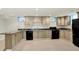 Spacious kitchen features granite counters, light cabinets, and modern black appliances at 8602 Frontgate Ln, Indianapolis, IN 46256