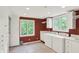 A spacious laundry room featuring white washer, dryer, storage cabinets and windows at 8602 Frontgate Ln, Indianapolis, IN 46256