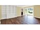 Bright living room featuring hardwood flooring, large window and built-in shelving at 8602 Frontgate Ln, Indianapolis, IN 46256