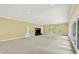 Spacious living room featuring neutral carpeting, fireplace and large windows at 8602 Frontgate Ln, Indianapolis, IN 46256