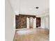 Bright and airy living room features hardwood floors and brick accent wall at 8602 Frontgate Ln, Indianapolis, IN 46256