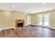 Living room with hardwood floors, a stone fireplace, and glass doors leading to the outside at 8602 Frontgate Ln, Indianapolis, IN 46256
