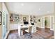 Bright home office features built-in shelving, wood floors, white desk, and lots of natural light at 8602 Frontgate Ln, Indianapolis, IN 46256