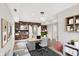 Home office boasts brick accent wall, modern decor and great natural light at 8602 Frontgate Ln, Indianapolis, IN 46256